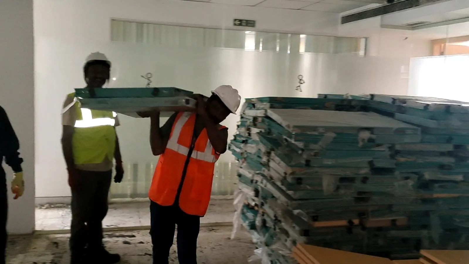 Deconstruction technicians dismantling complex modular workspace components cleanly inside an IT park block in Siruseri.